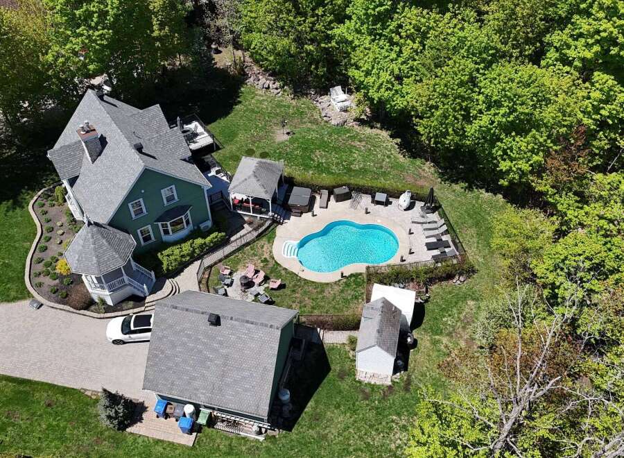 Discover your dream home with this stunning property featuring a beautiful pool and lush landscaping.