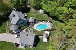 Discover your dream home with this stunning property featuring a beautiful pool and lush landscaping.