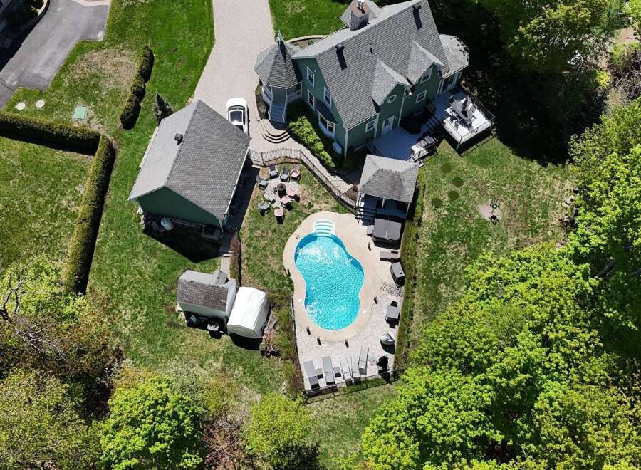 Discover luxury living in this stunning property featuring a private pool and lush landscaping.