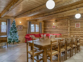 Step into this inviting chalet-style home, featuring a spacious dining area perfect for gatherings.