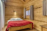 This cozy bedroom features beautiful wooden paneling, creating a warm and inviting atmosphere.