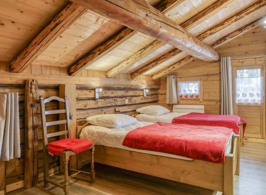 This charming bedroom features a rustic wooden interior, creating a warm and inviting atmosphere.