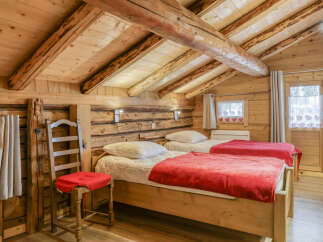 This charming bedroom features a rustic wooden interior, creating a warm and inviting atmosphere.