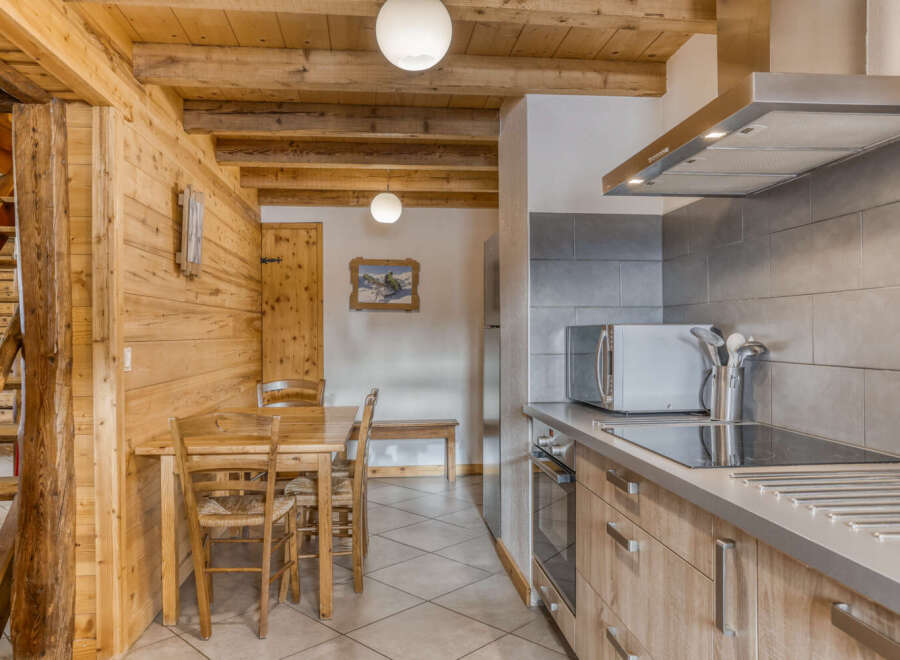 Step into this charming kitchen, featuring a rustic wooden design that exudes warmth and character.
