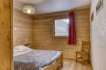 This cozy bedroom features beautiful wooden paneling, creating a warm and inviting atmosphere.