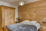 This cozy bedroom features a rustic wooden accent wall that adds warmth and character.