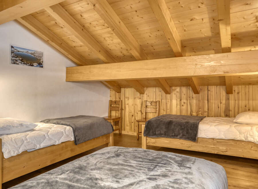 This cozy bedroom features a rustic wooden design, creating a warm and inviting atmosphere.