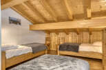 This cozy bedroom features a rustic wooden design, creating a warm and inviting atmosphere.