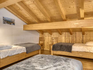 This cozy bedroom features a rustic wooden design, creating a warm and inviting atmosphere.