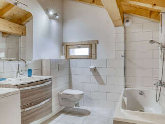 This charming bathroom features a modern design with a touch of rustic elegance.