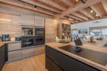 This stunning kitchen showcases a modern design with a rustic touch, perfect for a luxurious home.