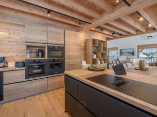 This stunning kitchen showcases a modern design with a rustic touch, perfect for a luxurious home.