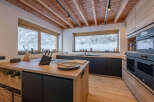 This stunning kitchen boasts a modern design with natural wood elements, creating a warm and inviting atmosphere.