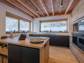 This stunning kitchen boasts a modern design with natural wood elements, creating a warm and inviting atmosphere.