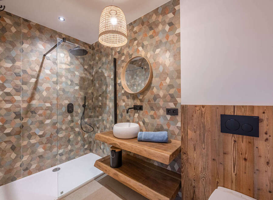 Step into a beautifully designed bathroom featuring a modern shower and stylish vanity.