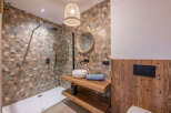 Step into a beautifully designed bathroom featuring a modern shower and stylish vanity.