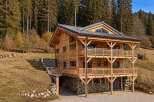 Discover the charm of this stunning wooden chalet nestled in a picturesque mountain setting.