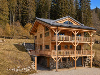 Discover the charm of this stunning wooden chalet nestled in a picturesque mountain setting.
