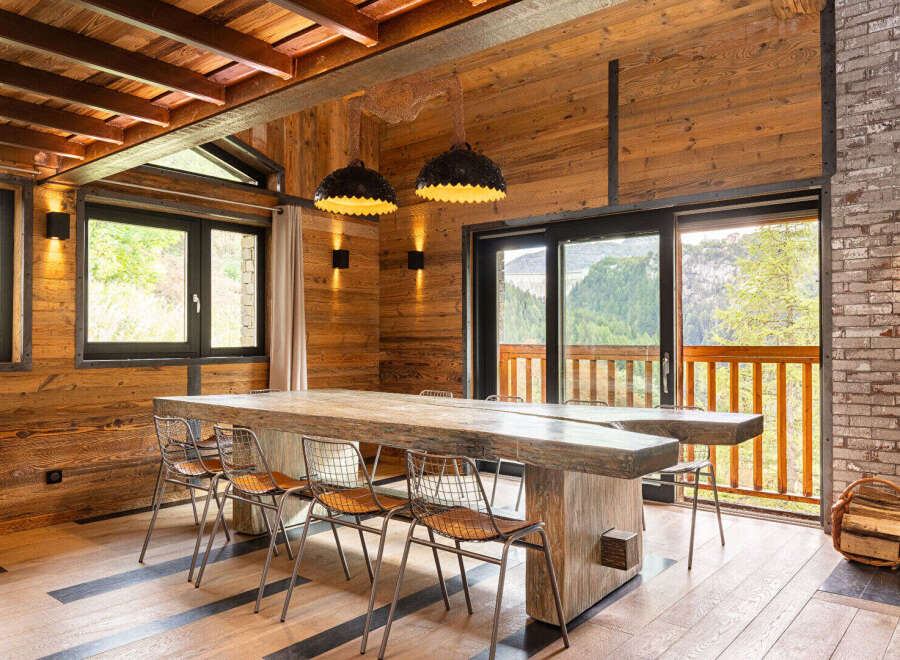 This stunning property boasts a rustic yet modern interior, perfect for those seeking a luxurious mountain retreat.
