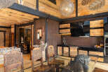 Experience rustic luxury in this stunning property, featuring a unique wooden interior and high ceilings.