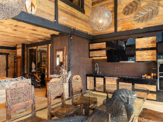 Experience rustic luxury in this stunning property, featuring a unique wooden interior and high ceilings.