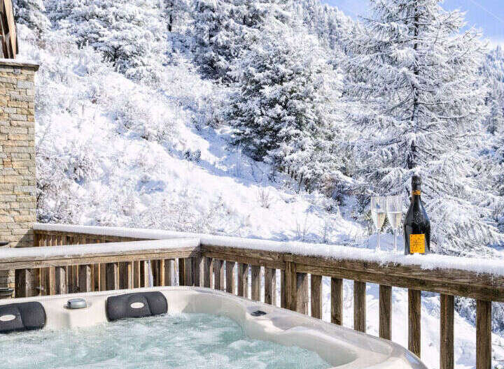 Indulge in luxury and tranquility with this stunning property featuring a private hot tub overlooking a breathtaking winter wonderland.