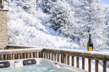Indulge in luxury and tranquility with this stunning property featuring a private hot tub overlooking a breathtaking winter wonderland.