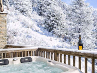 Indulge in luxury and tranquility with this stunning property featuring a private hot tub overlooking a breathtaking winter wonderland.