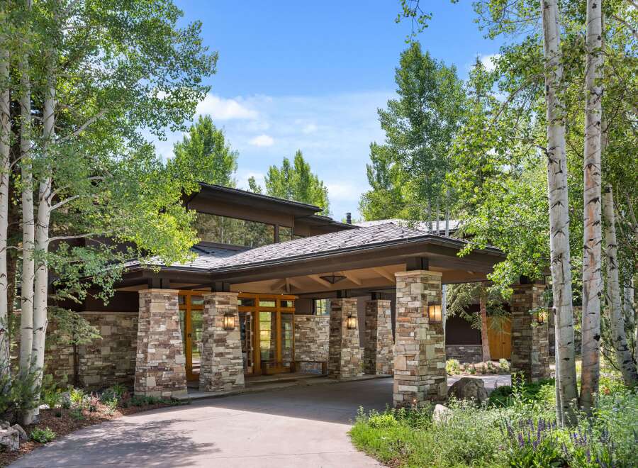 This stunning property boasts a beautiful stone facade and a welcoming entrance.