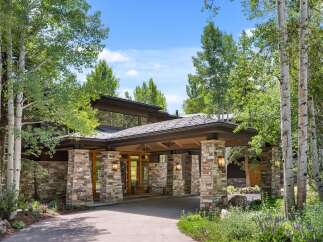 This stunning property boasts a beautiful stone facade and a welcoming entrance.