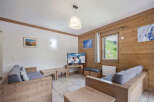 Discover the charm of this cozy living space, perfect for relaxing after a day on the slopes.