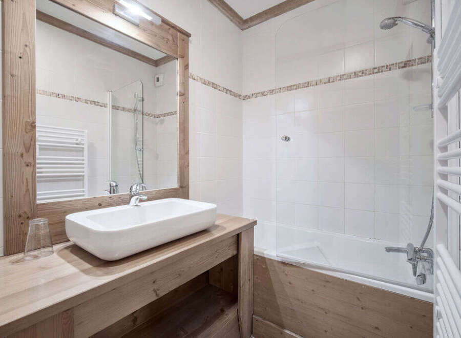 This charming bathroom features a modern design with a touch of rustic elegance.
