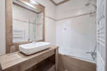 This charming bathroom features a modern design with a touch of rustic elegance.
