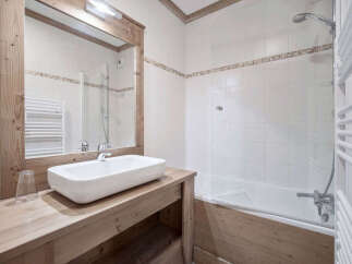 This charming bathroom features a modern design with a touch of rustic elegance.
