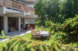 Enjoy al fresco dining on this charming patio, complete with a table set for a meal and comfortable seating.