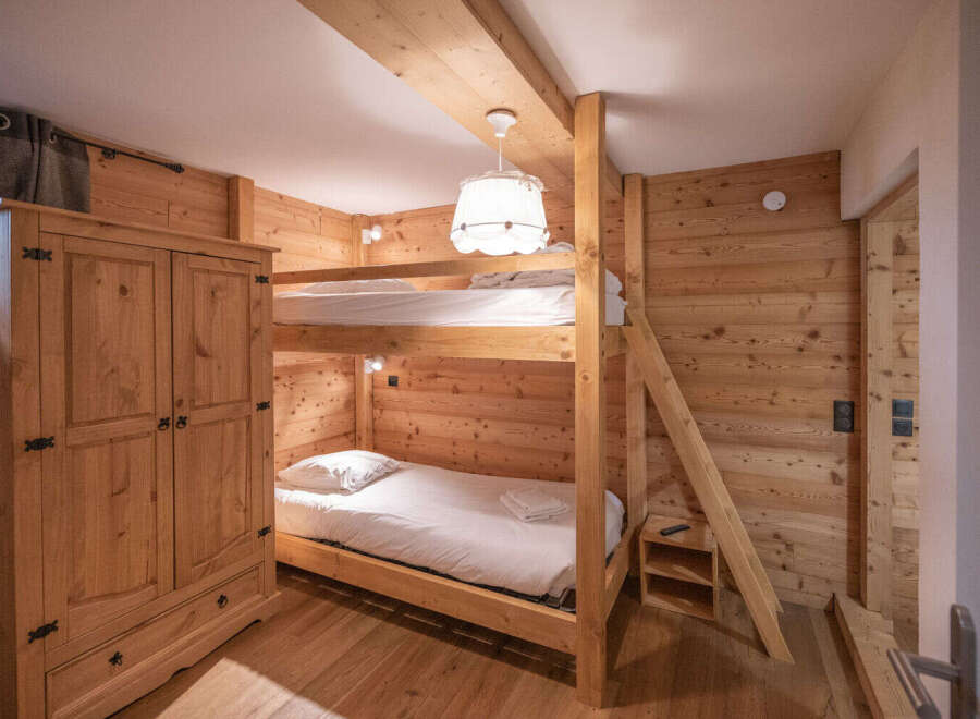 This charming bedroom features a cozy bunk bed setup, perfect for families or accommodating guests.