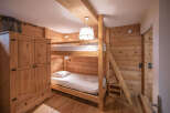This charming bedroom features a cozy bunk bed setup, perfect for families or accommodating guests.