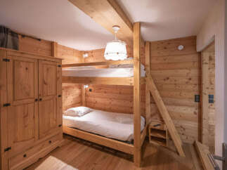 This charming bedroom features a cozy bunk bed setup, perfect for families or accommodating guests.