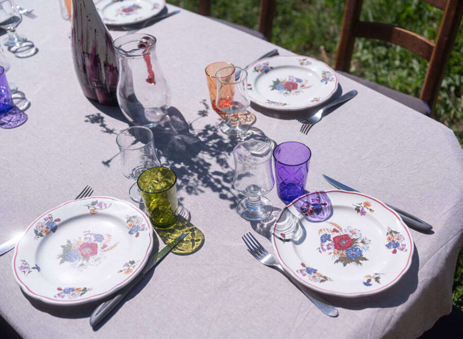 Enjoy an elegant outdoor dining experience with this beautifully set table, perfect for a garden party or intimate gathering.
