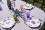 Enjoy an elegant outdoor dining experience with this beautifully set table, perfect for a garden party or intimate gathering.