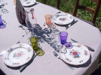 Enjoy an elegant outdoor dining experience with this beautifully set table, perfect for a garden party or intimate gathering.