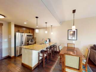 Step into luxury with this stunning kitchen and dining area! Featuring a spacious island with seating, stainless steel appliances, and elegant pendant lighting, this space is perfect for both cooking and entertaining.