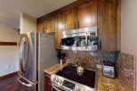 This stunning kitchen boasts modern appliances and elegant wooden cabinetry, perfect for culinary enthusiasts.