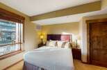 This inviting bedroom features a comfortable bed with plush pillows, perfect for a relaxing retreat.