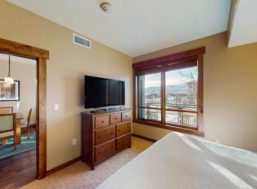 This inviting bedroom features a large window offering stunning views and ample natural light.