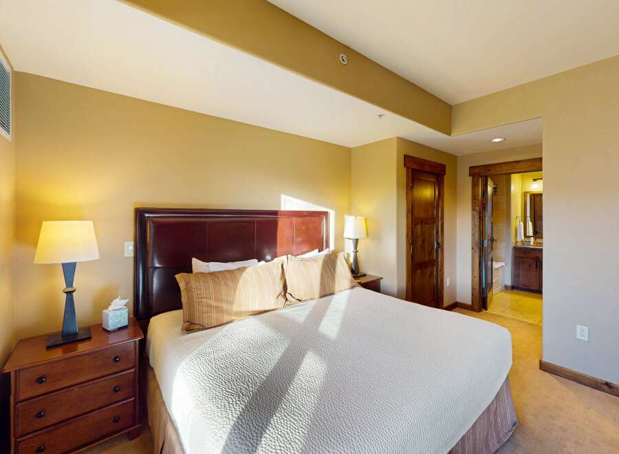 This luxurious bedroom features a comfortable king-sized bed with a stylish headboard and plush pillows.