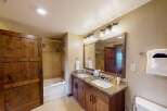 This stunning bathroom features a double vanity with a granite countertop, offering ample space for your daily routines.