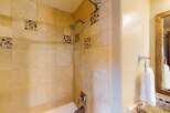 Step into a beautifully designed bathroom featuring elegant tile work and a modern shower head.