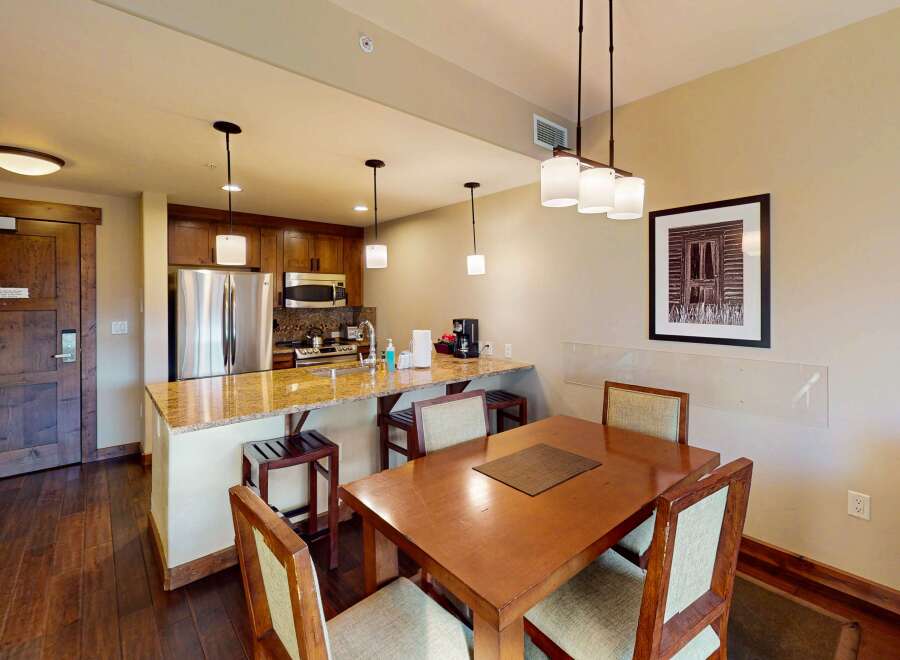 This stunning property features a modern kitchen with stainless steel appliances and a breakfast bar, perfect for casual dining.