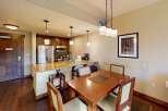 This stunning property features a modern kitchen with stainless steel appliances and a breakfast bar, perfect for casual dining.